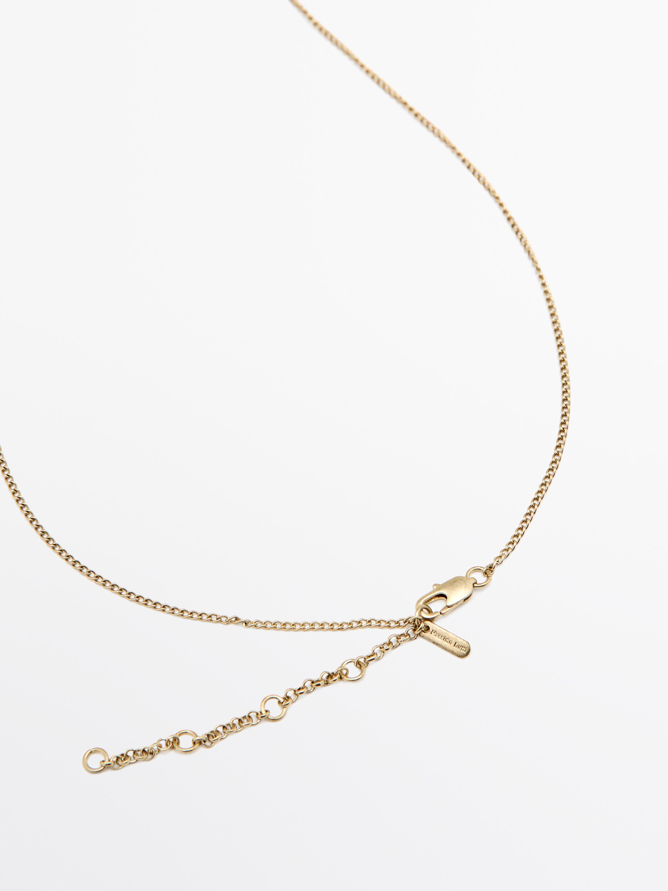 Necklace with metal piece
